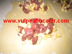 Amestecul de catofi, napi si carne pus pe foaia de aluat.